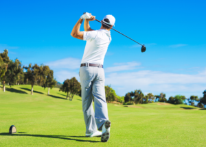 golfer teeing off 