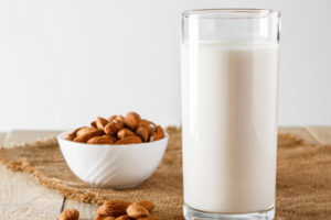 glass of milk and bowl of almonds 