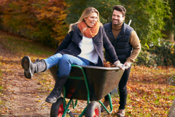 couple raking leaves 